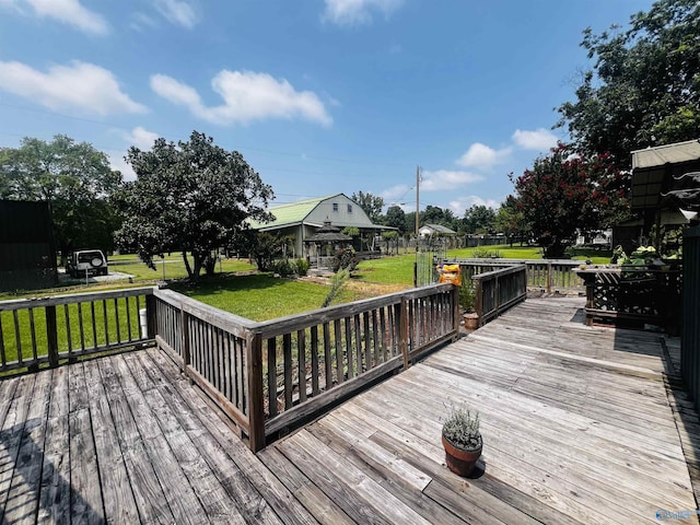 wooden terrace featuring a yard