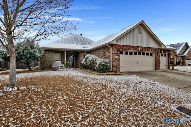 view of front of house featuring a garage, brick siding, and driveway