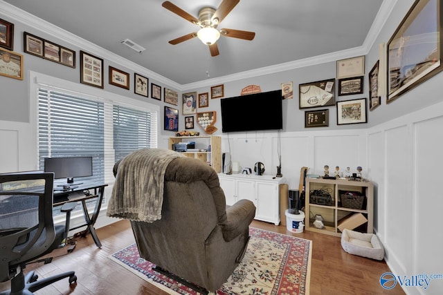 home office featuring ornamental molding, wood finished floors, visible vents, and a decorative wall