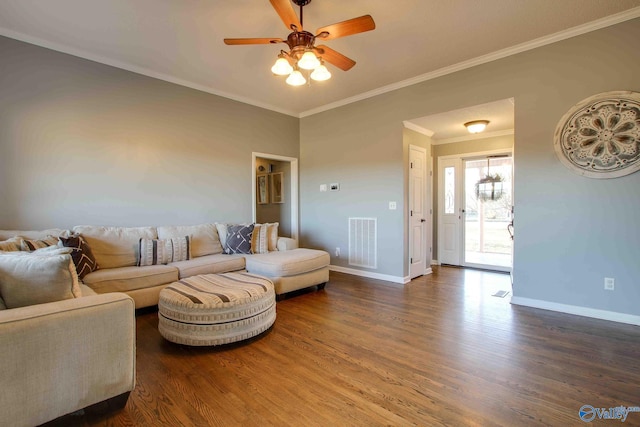 living room with dark hardwood / wood-style flooring, ceiling fan, and crown molding