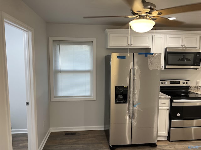 212 Nelson St NW, Hartselle, AL 35640 - kitchen featuring white cabinetry, a healthy amount of sunlight, stainless steel appliances, dark hardwood / wood-style flooring, and light stone counters