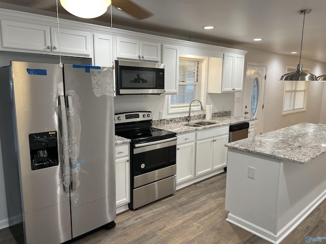 212 Nelson St NW, Hartselle, AL 35640 - kitchen featuring stainless steel appliances, white cabinetry, hanging light fixtures, and sink