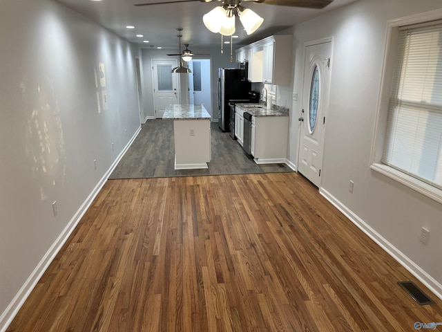 212 Nelson St NW, Hartselle, AL 35640 - kitchen featuring ceiling fan, a center island, light stone countertops, white cabinets, and dark hardwood / wood-style flooring