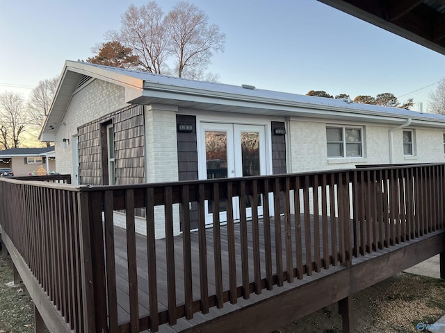 212 Nelson St NW, Hartselle, AL 35640 - back house at dusk with french doors and a deck
