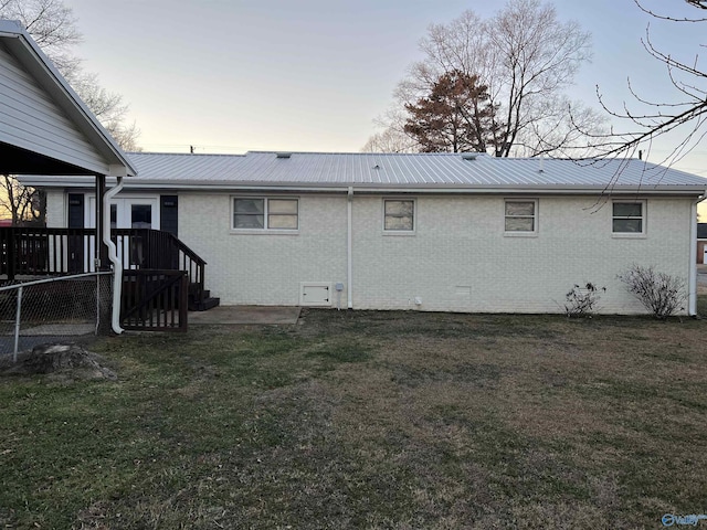 212 Nelson St NW, Hartselle, AL 35640 - back house at dusk featuring a lawn