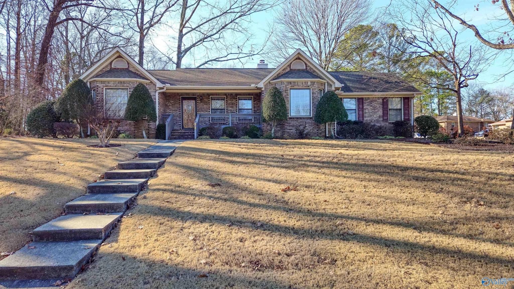 view of front of house featuring a front yard and covered porch