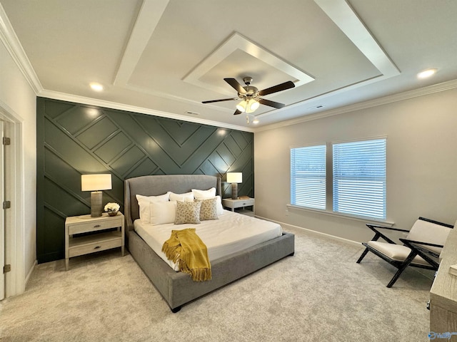 carpeted bedroom featuring ceiling fan, crown molding, and a tray ceiling