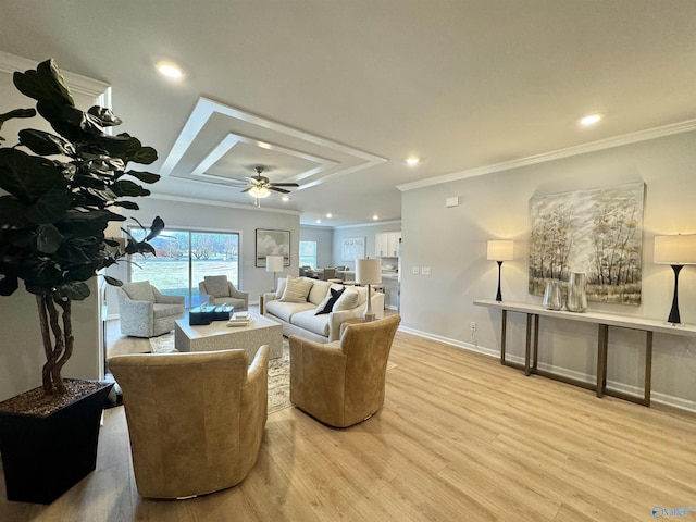 living room featuring ceiling fan, light wood-type flooring, and ornamental molding