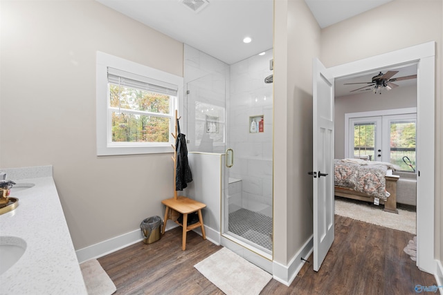 bathroom with vanity, french doors, ceiling fan, walk in shower, and wood-type flooring