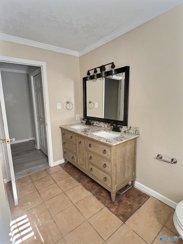 bathroom featuring toilet, vanity, tile patterned floors, and ornamental molding