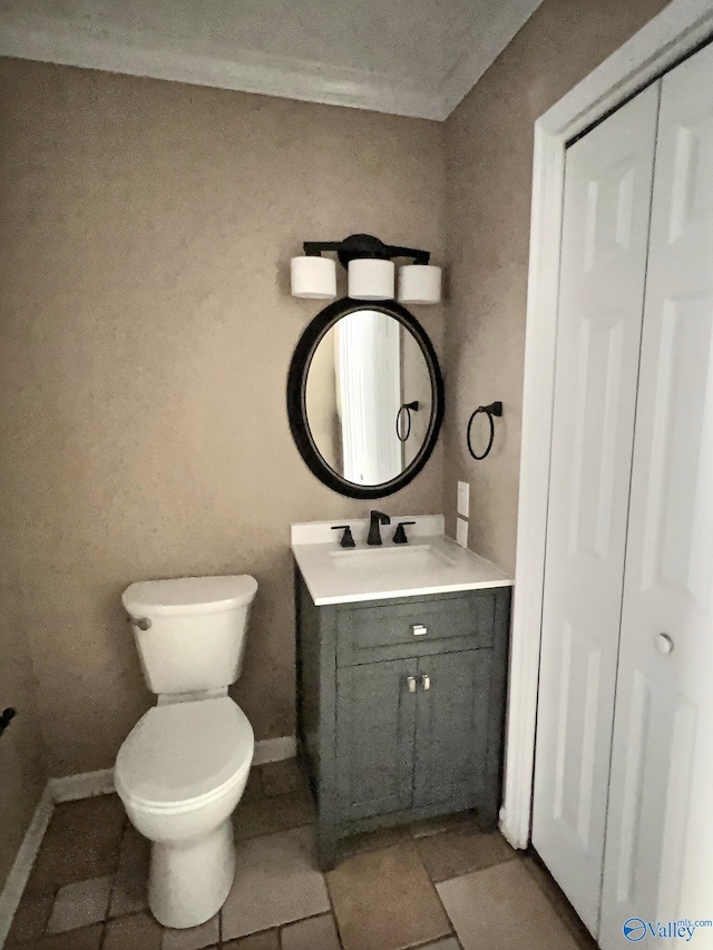 bathroom featuring tile patterned floors, vanity, and toilet