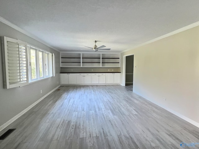 unfurnished living room featuring hardwood / wood-style flooring, ceiling fan, ornamental molding, and a textured ceiling