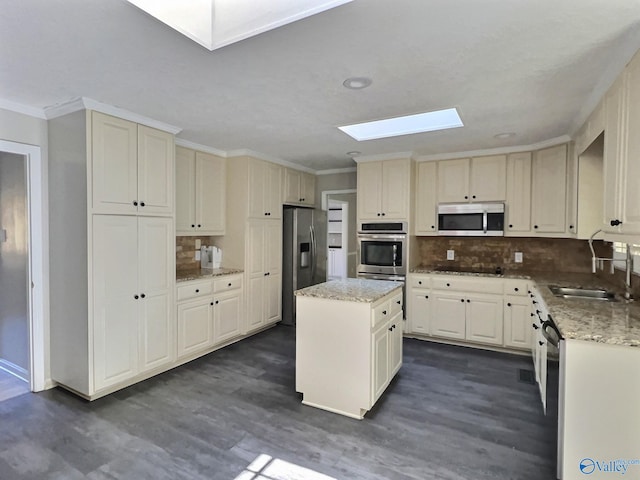 kitchen with a center island, sink, stainless steel appliances, and dark wood-type flooring