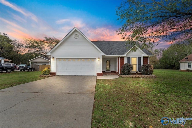 ranch-style home with a yard and a garage