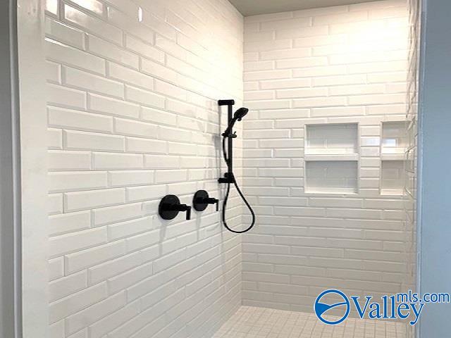 bathroom with a tile shower