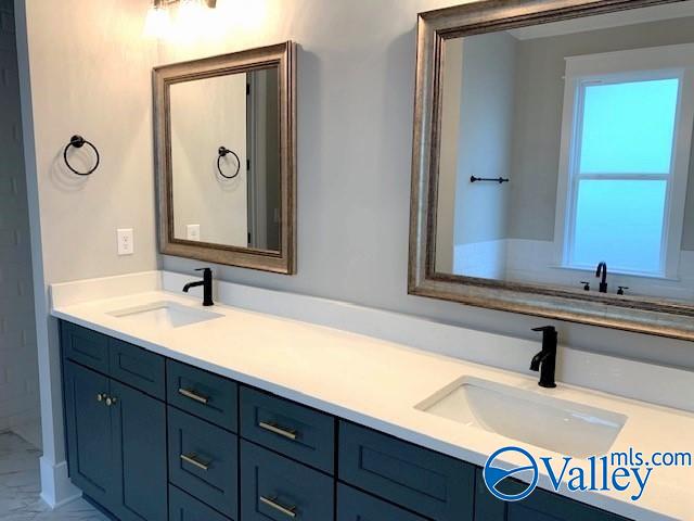 bathroom featuring tile patterned flooring and double sink vanity