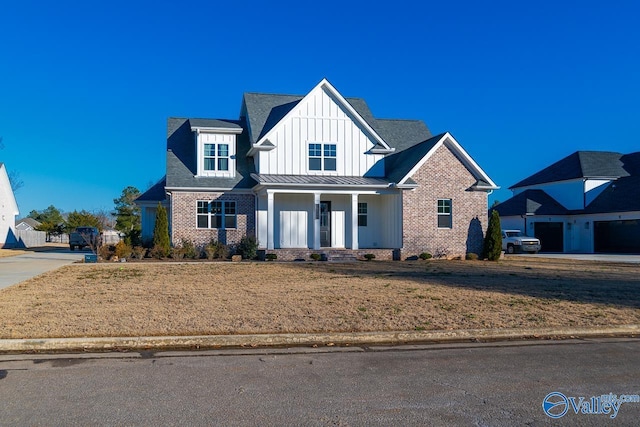 view of front of house featuring a garage, a front lawn, and covered porch