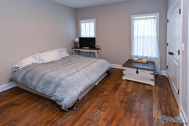 bedroom with dark wood-type flooring