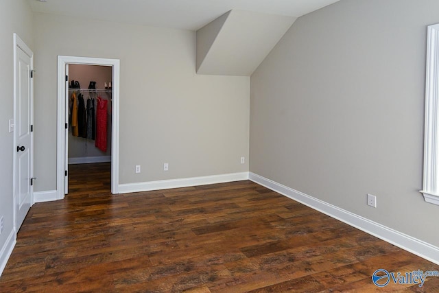 interior space featuring dark hardwood / wood-style floors and vaulted ceiling