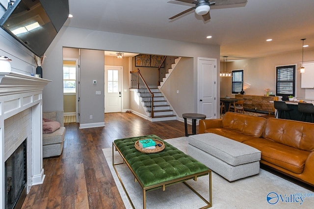 living room with ceiling fan and dark hardwood / wood-style flooring