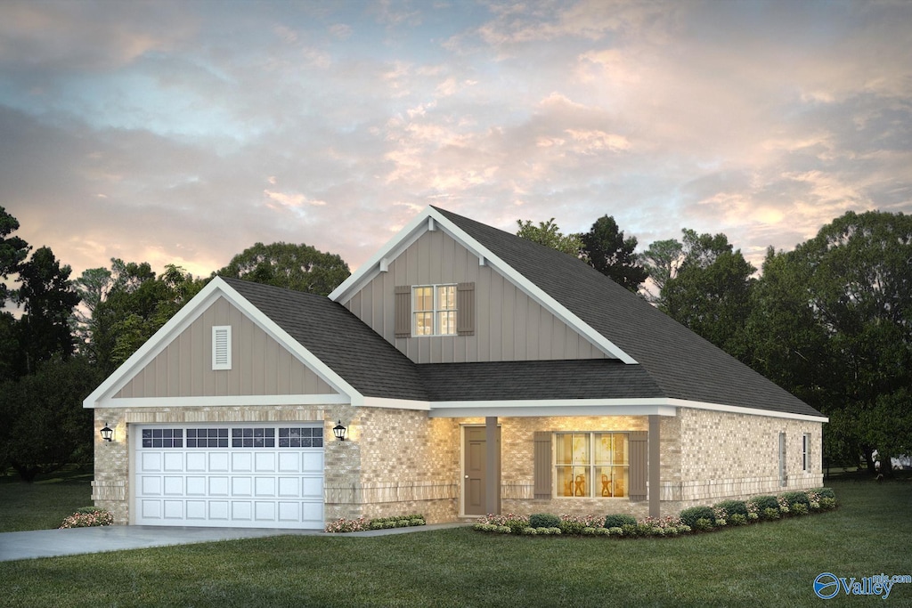 view of front of house with a garage and a yard