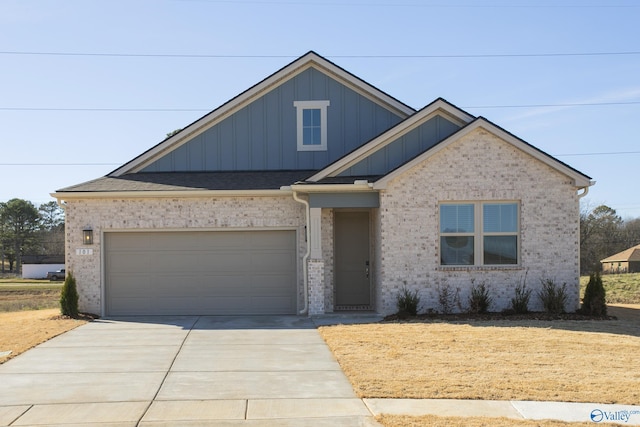 view of front of property with driveway, an attached garage, board and batten siding, and brick siding