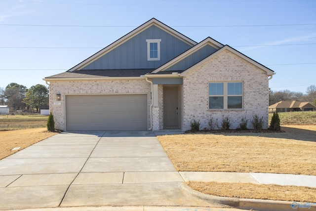 view of front of house featuring a garage, brick siding, driveway, and board and batten siding