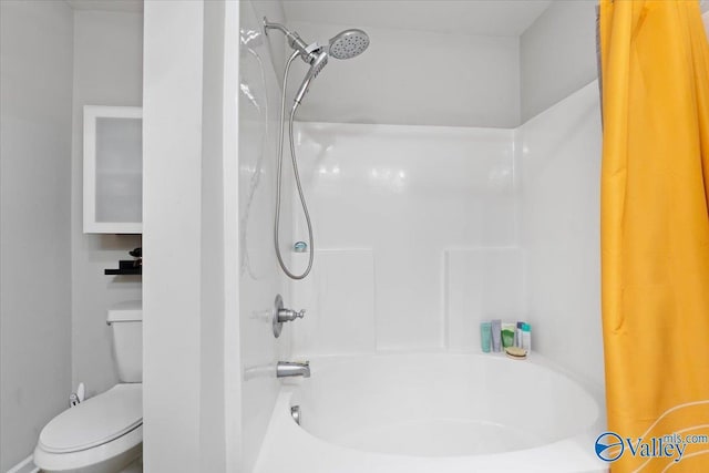 bathroom with shower / bath combination with curtain and toilet