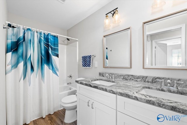 full bathroom featuring shower / bathtub combination with curtain, wood-type flooring, vanity, and toilet