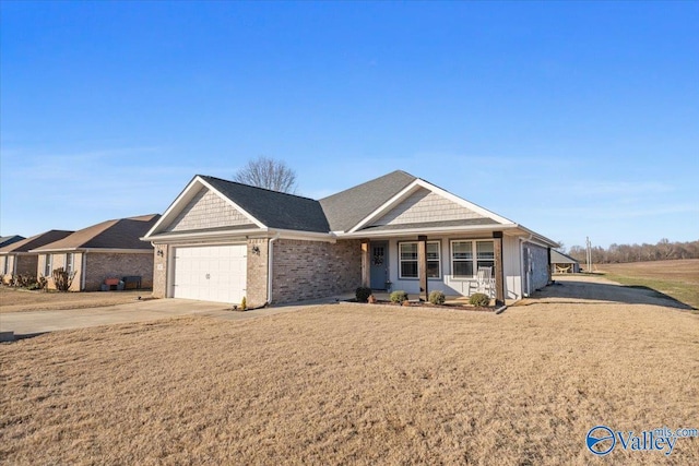 ranch-style home featuring a porch, a front yard, and a garage