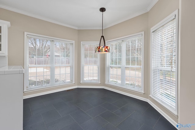 unfurnished dining area featuring crown molding and a healthy amount of sunlight