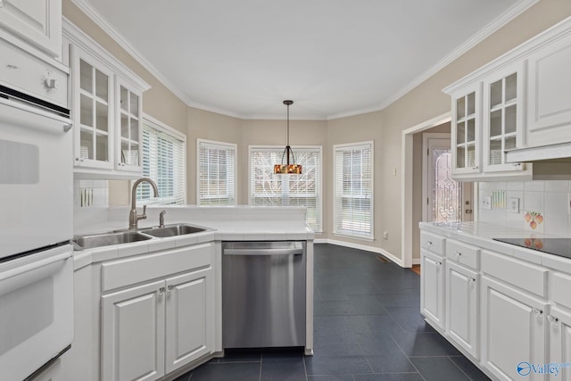 kitchen featuring sink, dishwasher, white cabinetry, double oven, and tile counters