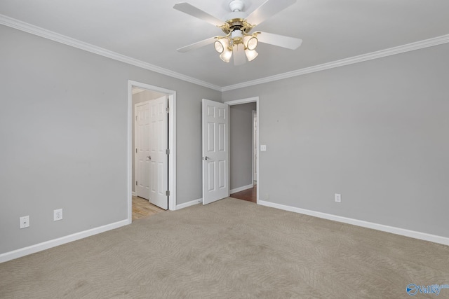 carpeted empty room featuring crown molding and ceiling fan