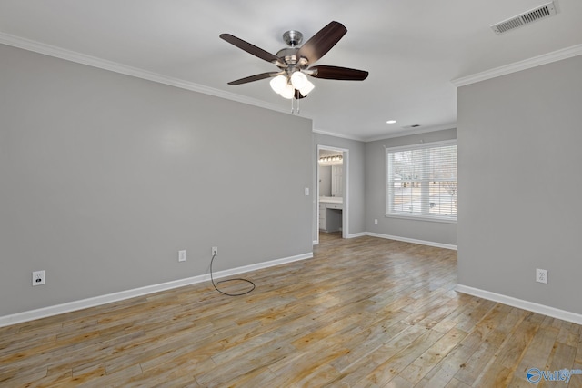 empty room with ornamental molding, ceiling fan, and light wood-type flooring