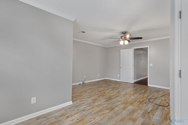 empty room featuring ornamental molding, ceiling fan, and light hardwood / wood-style flooring