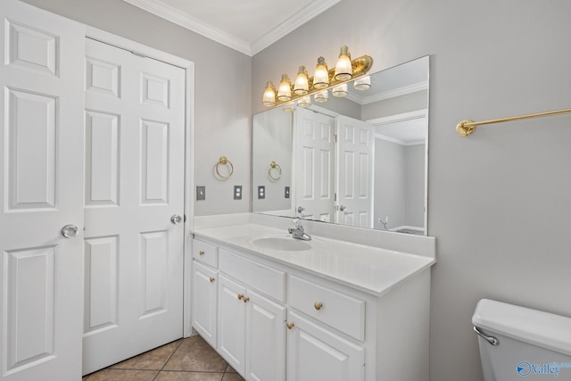 bathroom with ornamental molding, toilet, tile patterned flooring, and vanity