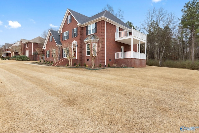 front of property with a front yard and a balcony