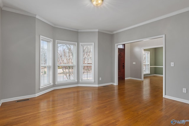 spare room with crown molding and hardwood / wood-style floors