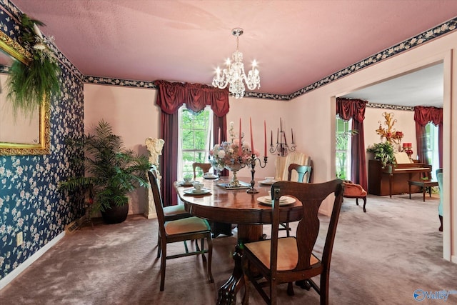 carpeted dining area featuring wallpapered walls, a chandelier, and baseboards