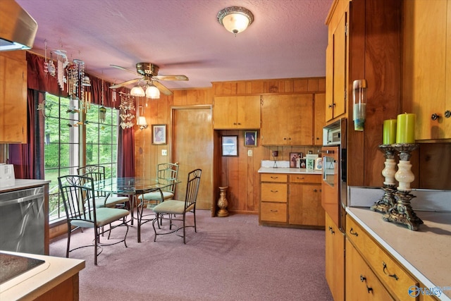 kitchen featuring dishwasher, ceiling fan, a wealth of natural light, and light countertops