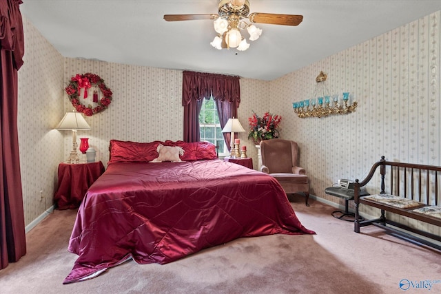 carpeted bedroom featuring baseboards, wallpapered walls, and a ceiling fan