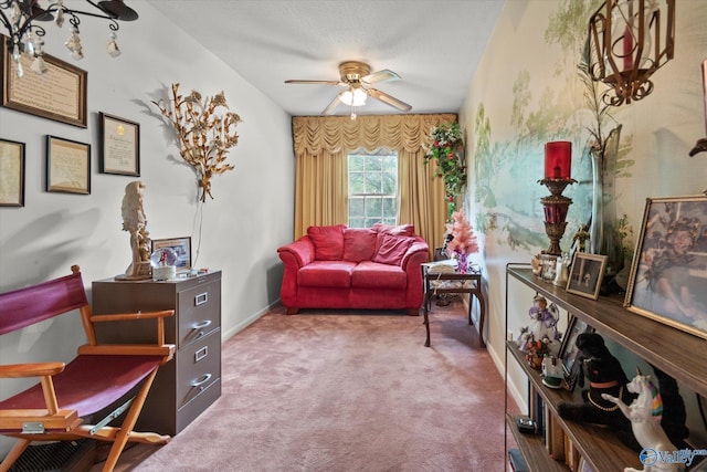 sitting room with ceiling fan and carpet flooring