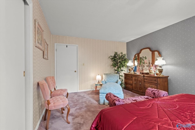 bedroom with wallpapered walls and carpet flooring