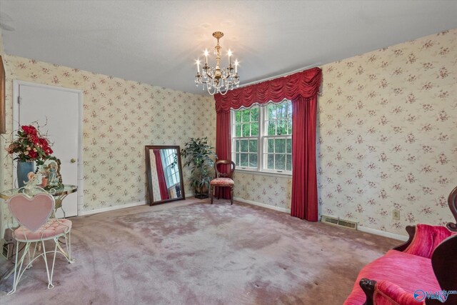 sitting room with carpet flooring, a chandelier, visible vents, baseboards, and wallpapered walls