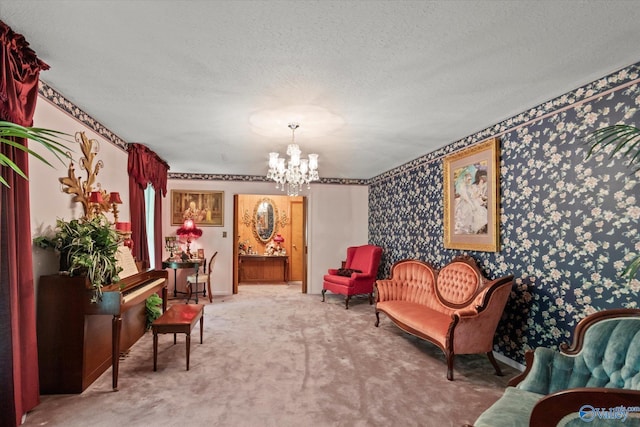 living area featuring carpet, a chandelier, wallpapered walls, and a textured ceiling