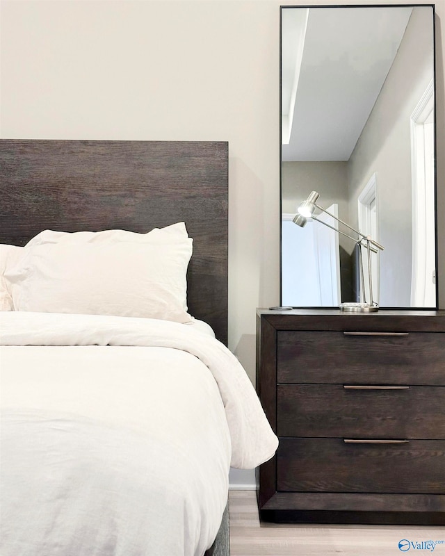 bedroom with wood-type flooring