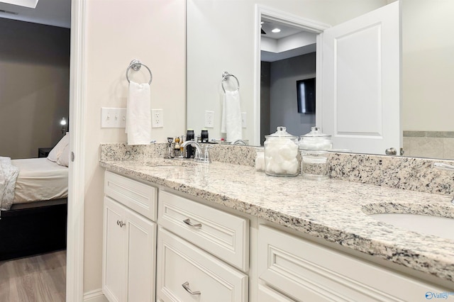 bathroom with hardwood / wood-style floors and vanity