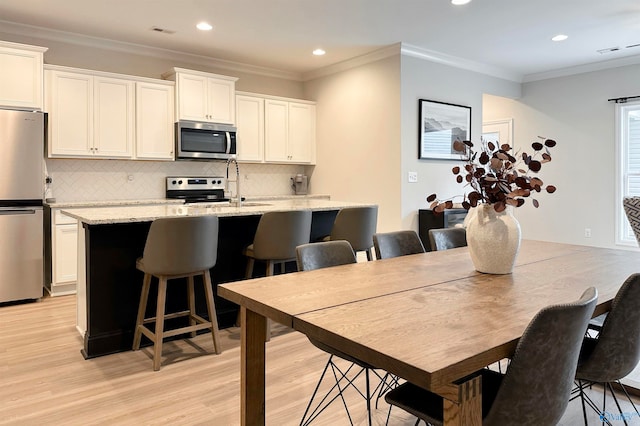 interior space featuring light hardwood / wood-style floors and crown molding