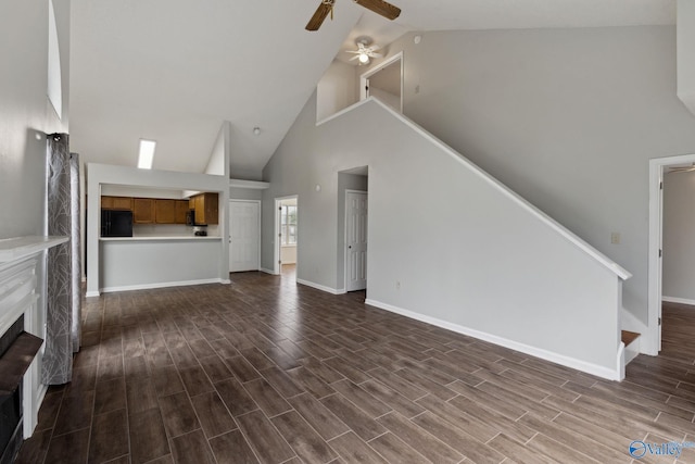 unfurnished living room featuring a high end fireplace, high vaulted ceiling, and ceiling fan