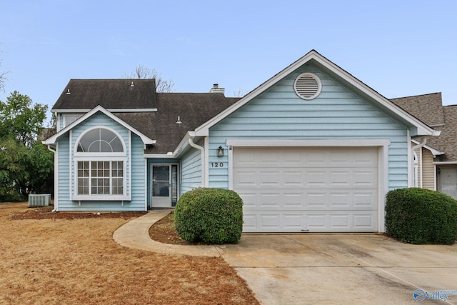 view of front of home featuring a garage and cooling unit